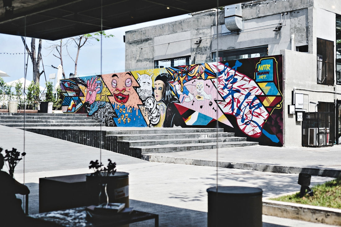 brown and multicolored wall with art at daytime