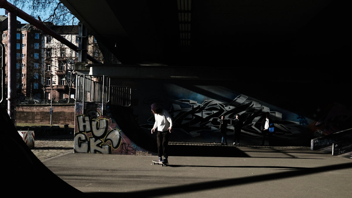 woman in white long sleeve shirt and black pants walking on sidewalk