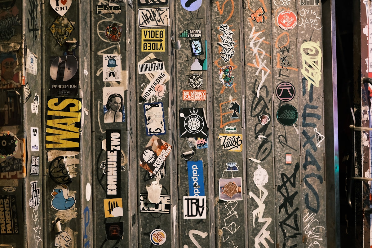 A bunch of stickers are on a wall