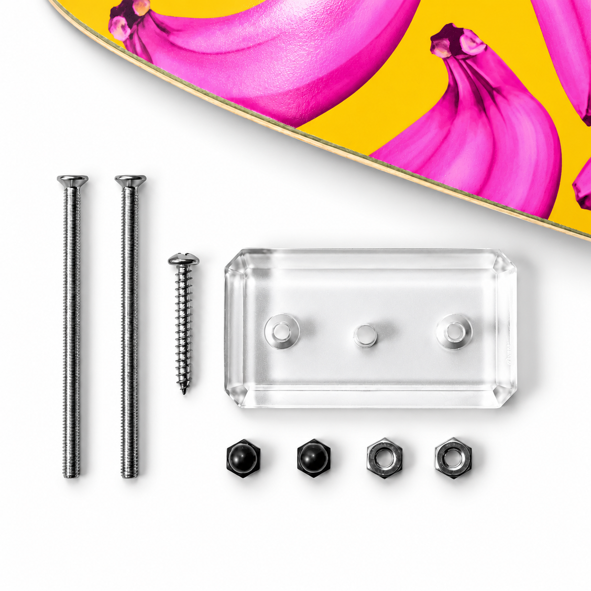 Clear acrylic skateboard wall mount kit: two steel rods, wall screw, nuts and black cap nuts beside a pink-banana deck